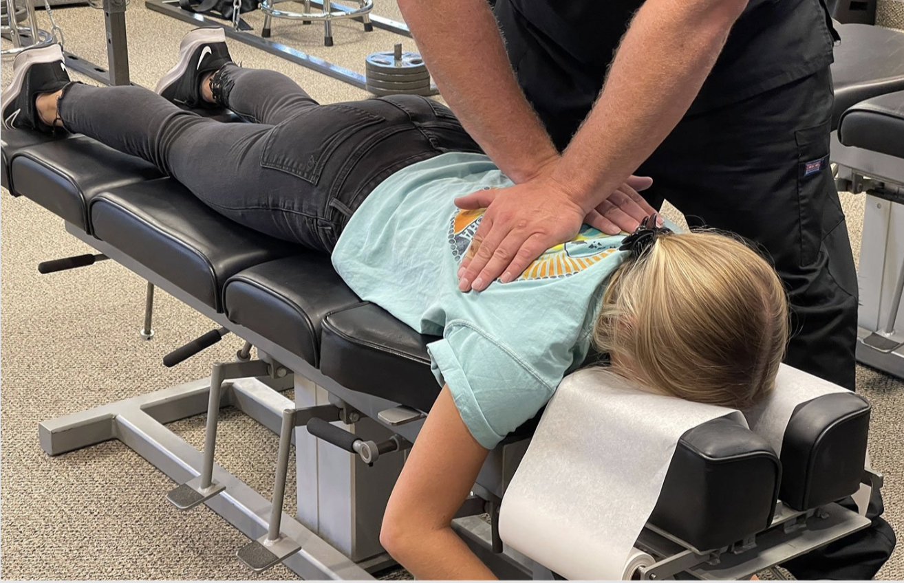 Chiropractic adjustment on prone patient